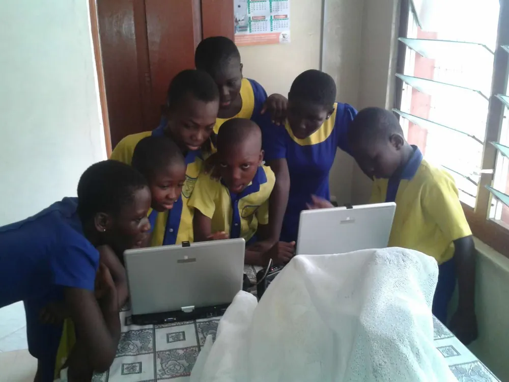 Lovia pupils working together at laptop computers.