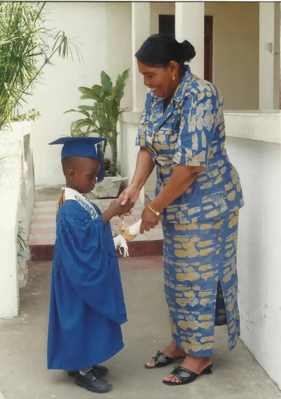 Lovia School founder Mrs. Gladys Darkwa congratulating a graduate.